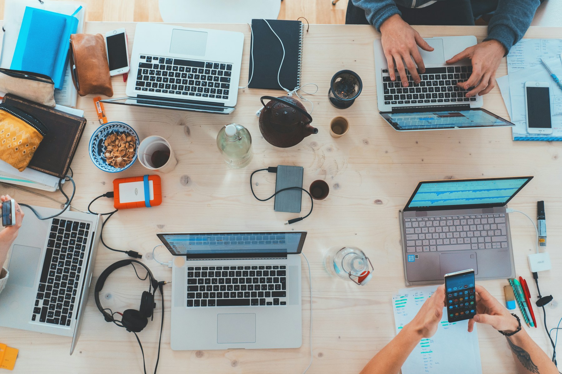 Photo: Marvin Meyer / Unsplash Digital team working together with laptops and mobile devices