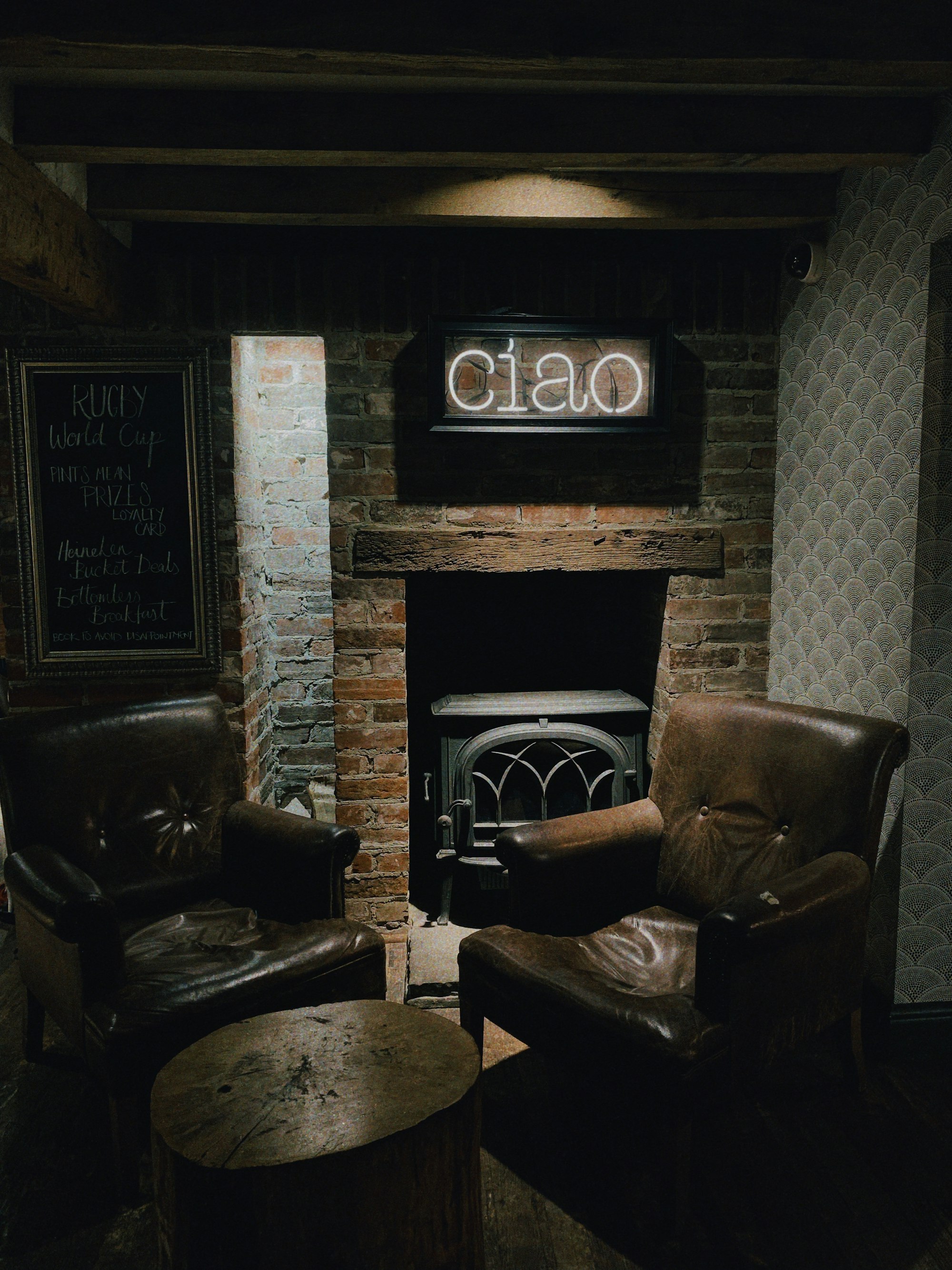 Photo: Toa Heftiba / Unsplash Leather lounge chairs beside a fireplace in an intimate social lounge